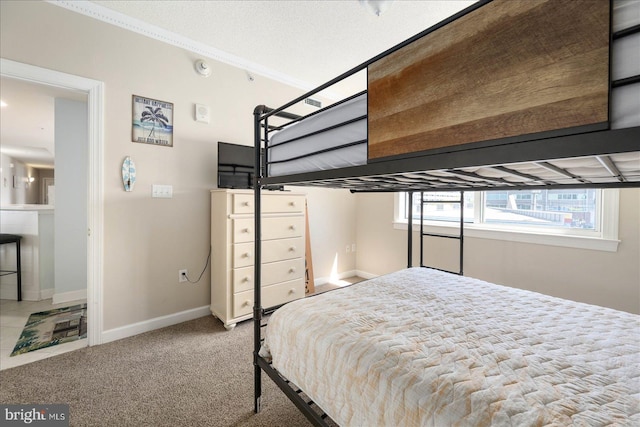 bedroom with carpet floors and a textured ceiling