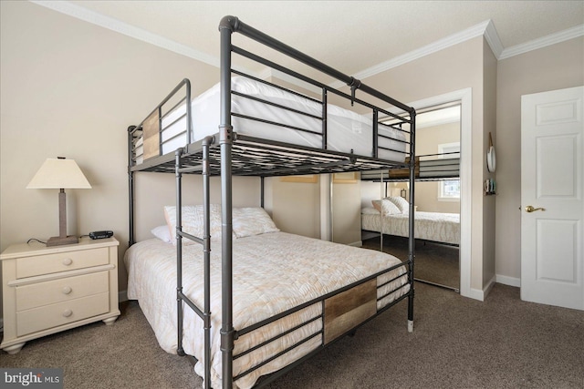 bedroom featuring ornamental molding, a closet, and dark colored carpet