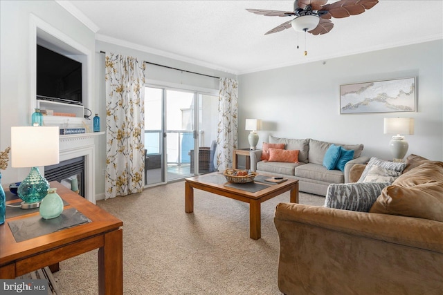 carpeted living room featuring ceiling fan and ornamental molding