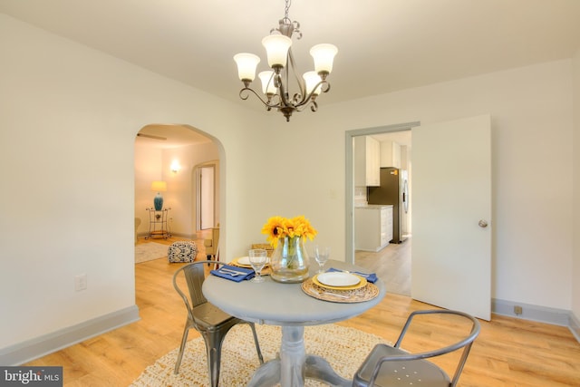 dining space featuring a chandelier and light hardwood / wood-style flooring