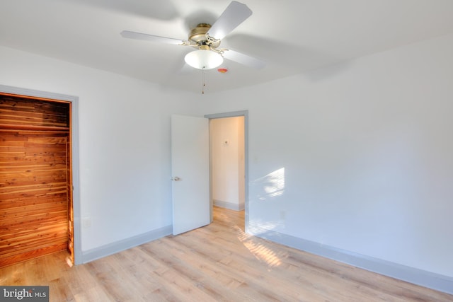 unfurnished bedroom featuring ceiling fan, a closet, and light hardwood / wood-style floors