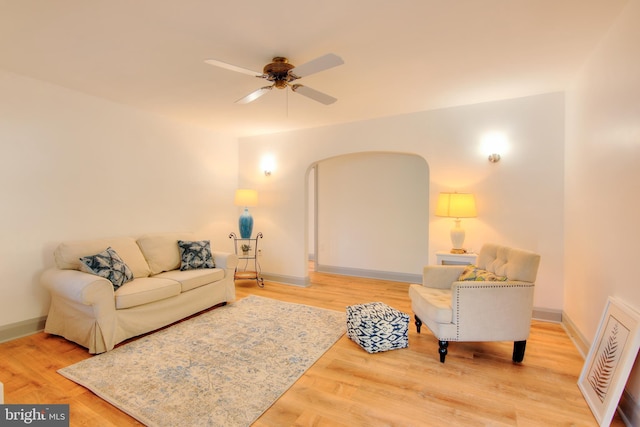 living room with hardwood / wood-style floors and ceiling fan