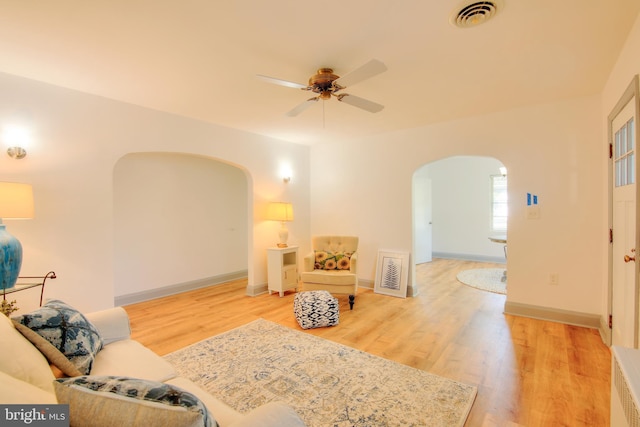 living room featuring ceiling fan and hardwood / wood-style flooring