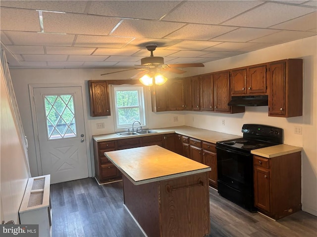 kitchen with ceiling fan, sink, a kitchen island, black electric range, and dark hardwood / wood-style flooring