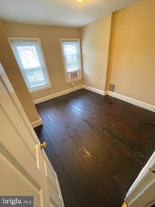 unfurnished room with dark hardwood / wood-style floors