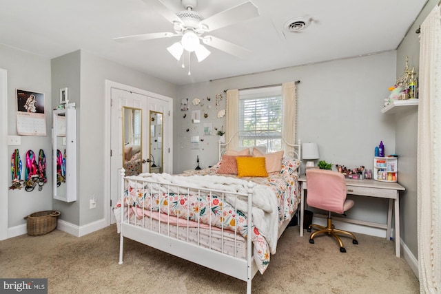 bedroom with built in desk, ceiling fan, and carpet floors