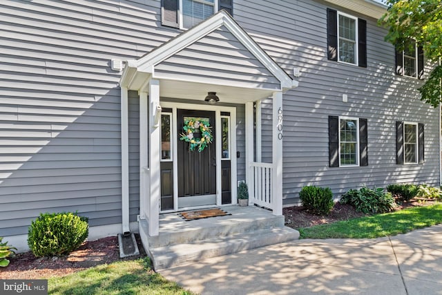 view of exterior entry with covered porch