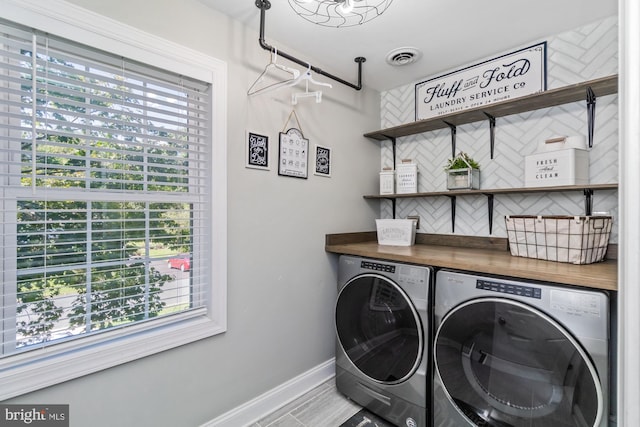 washroom featuring washer and clothes dryer