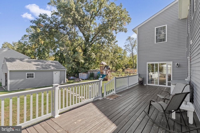 wooden deck featuring a storage unit and a lawn