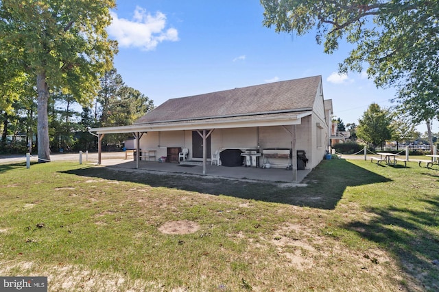 back of property featuring a patio and a yard