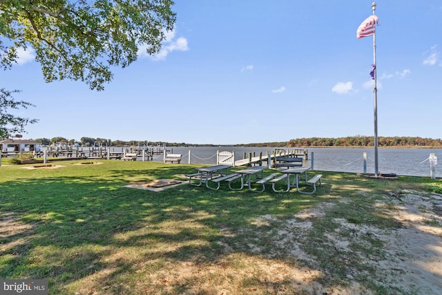 view of dock featuring a yard and a water view