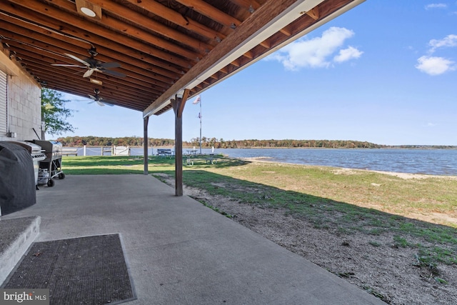 view of patio / terrace featuring a water view and ceiling fan