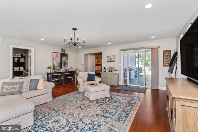 living room featuring an inviting chandelier and dark hardwood / wood-style floors