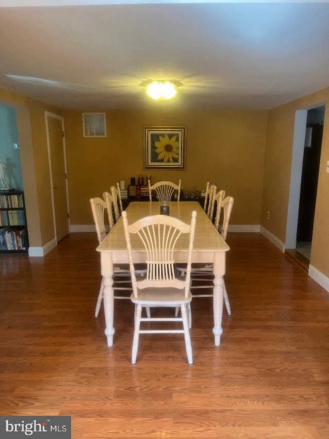 dining area with wood-type flooring