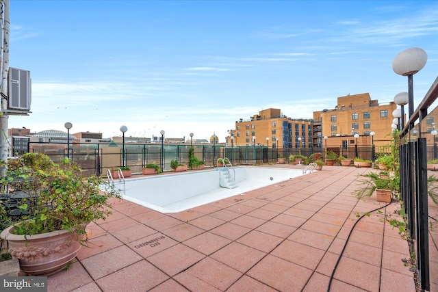 view of swimming pool featuring a patio area