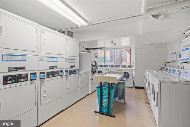 laundry room featuring washing machine and clothes dryer and stacked washing maching and dryer