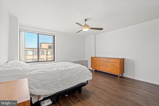 bedroom with ceiling fan and dark hardwood / wood-style floors