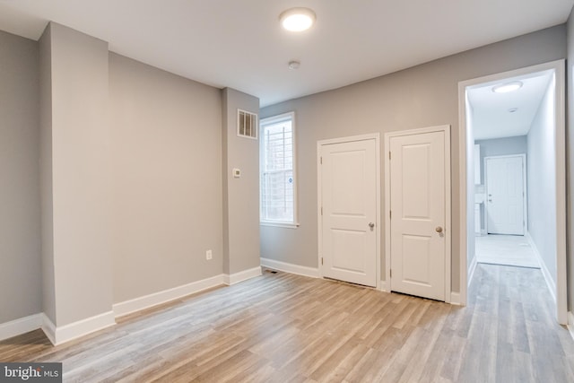 unfurnished bedroom featuring light wood-type flooring