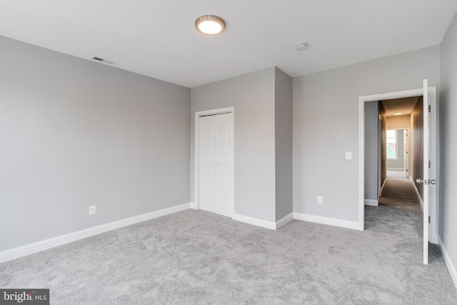 unfurnished bedroom with light colored carpet