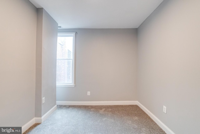 spare room featuring light colored carpet