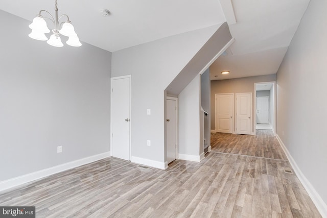 interior space with a chandelier and light hardwood / wood-style floors