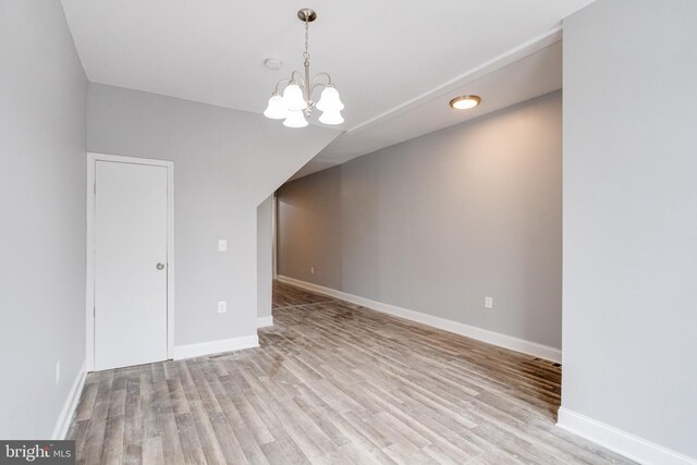 interior space featuring light wood-type flooring and a chandelier