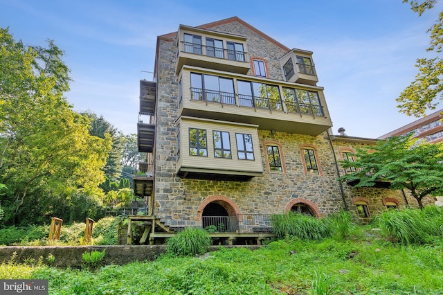 back of house featuring a balcony