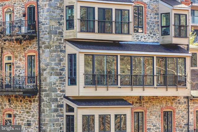 rear view of property with a balcony