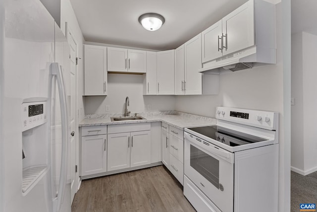 kitchen with light stone counters, sink, white appliances, white cabinetry, and light hardwood / wood-style floors