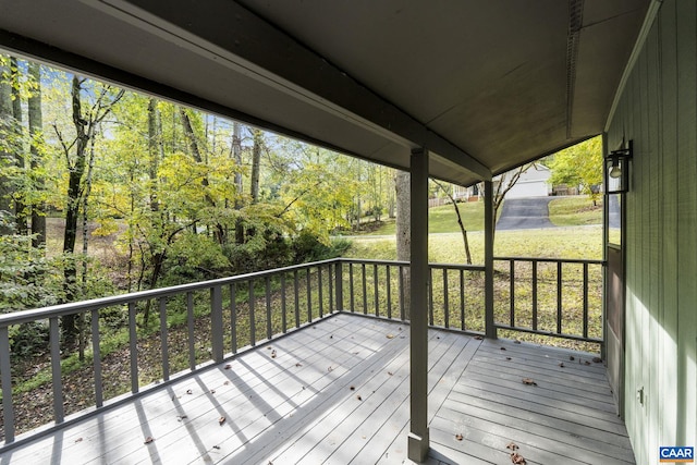 wooden deck with a lawn