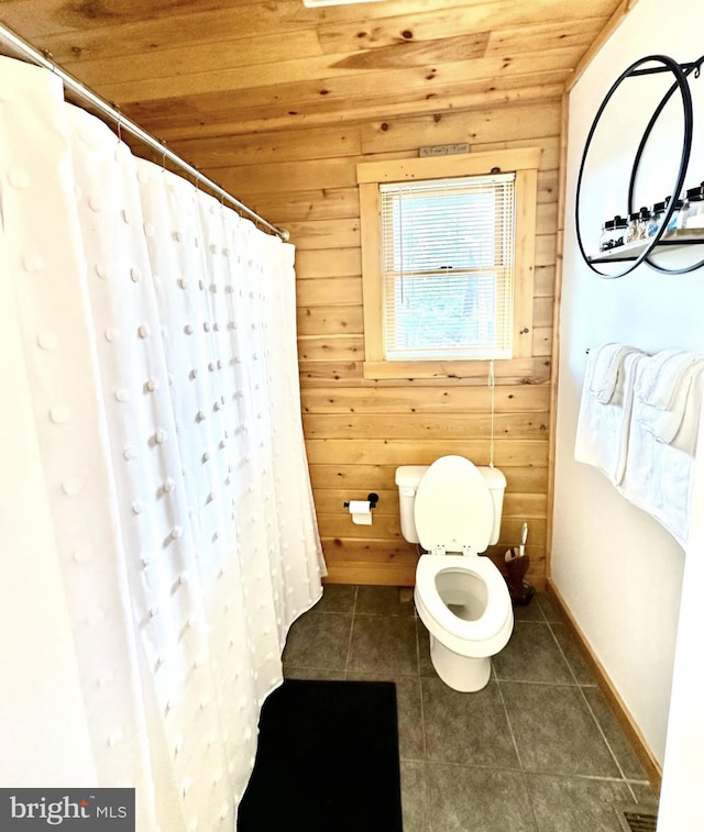 bathroom with wood ceiling, wood walls, tile patterned flooring, a shower with curtain, and toilet