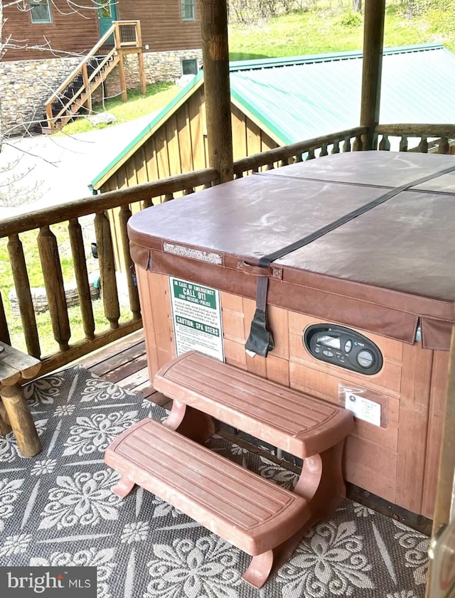 wooden deck featuring a hot tub