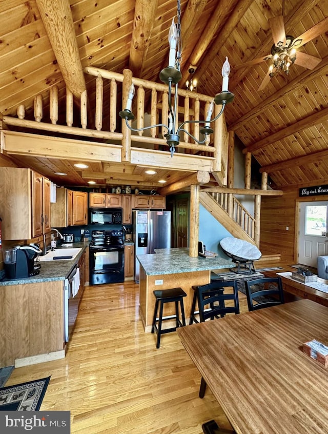 kitchen featuring lofted ceiling with beams, light hardwood / wood-style floors, sink, black appliances, and wooden ceiling