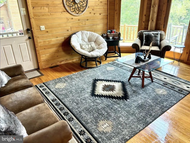 living room featuring wooden walls and hardwood / wood-style floors