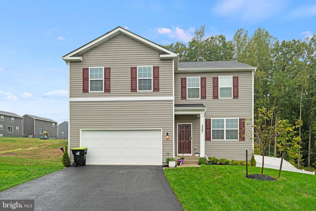 view of front of home with a garage and a front yard