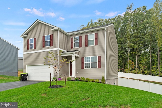 view of front of house featuring a garage and a front lawn