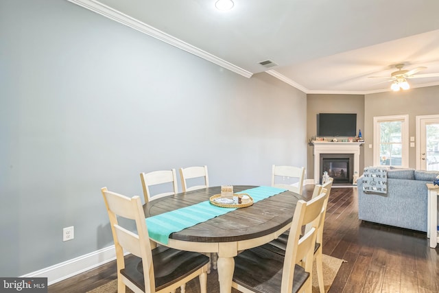 dining area with ceiling fan, crown molding, and dark hardwood / wood-style flooring