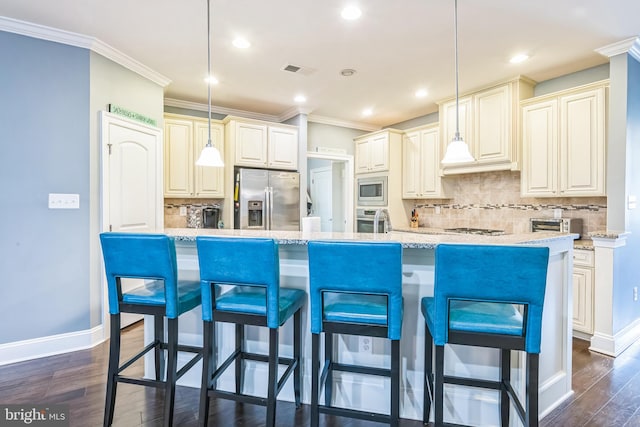 kitchen with decorative light fixtures, stainless steel appliances, dark wood-type flooring, and a kitchen breakfast bar