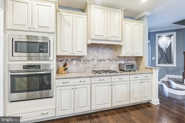 kitchen featuring crown molding, dark hardwood / wood-style floors, stainless steel appliances, and tasteful backsplash