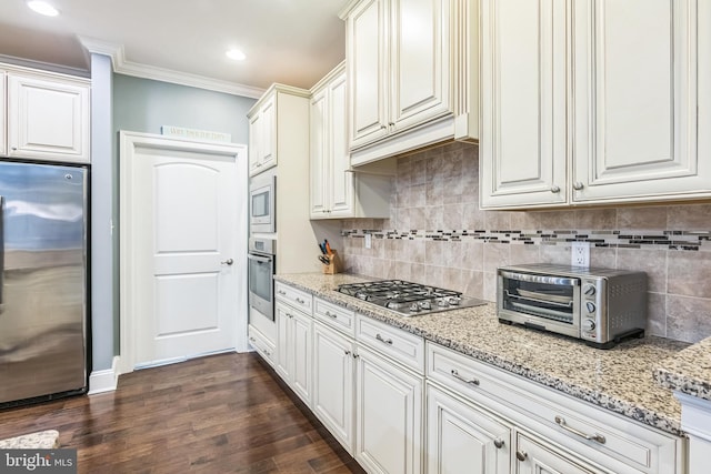 kitchen featuring stainless steel appliances, dark hardwood / wood-style floors, ornamental molding, and white cabinetry