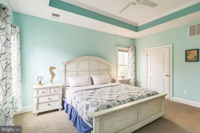 bedroom with crown molding, ceiling fan, and a raised ceiling