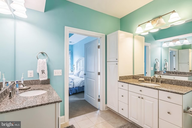 bathroom with tile patterned floors and vanity