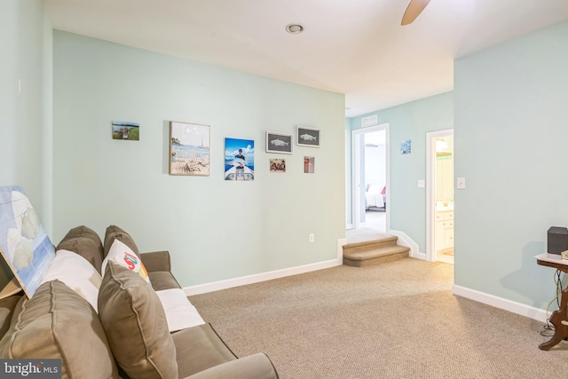 living room with ceiling fan and light colored carpet