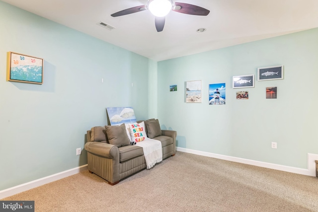 sitting room with ceiling fan and light colored carpet