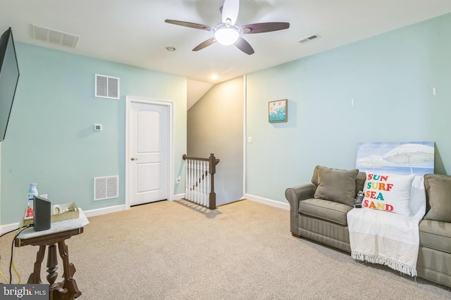 sitting room with ceiling fan and light carpet