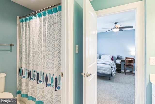 bathroom featuring ceiling fan, toilet, and a shower with shower curtain