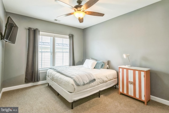 bedroom with ceiling fan and light colored carpet