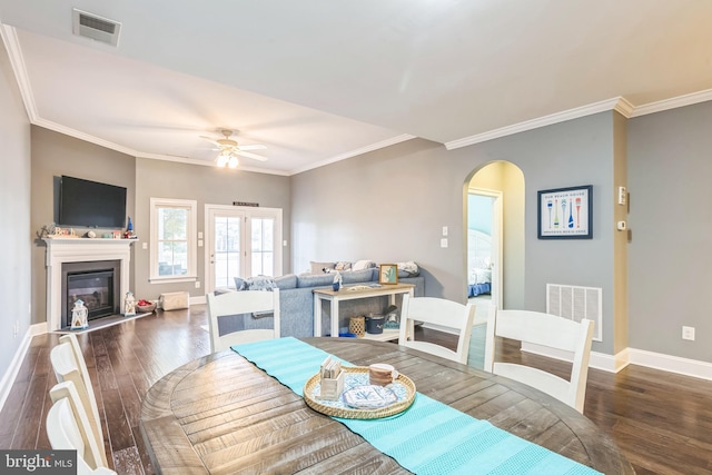 dining room with crown molding, dark hardwood / wood-style floors, and ceiling fan