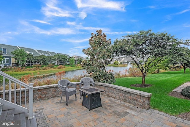 view of patio / terrace with a water view and an outdoor fire pit