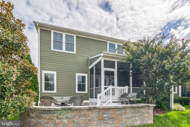 back of house featuring a patio and a sunroom